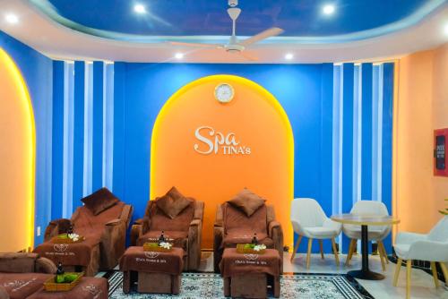 a room with three chairs and a sign on a wall at Tina's House & Spa - Sunset Town Phu Quoc in Phu Quoc