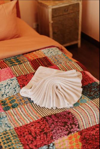 a white robe laying on top of a bed at Palm Villa - Award Winning Modern Luxury & Exclusive Villa in Chiang Mai