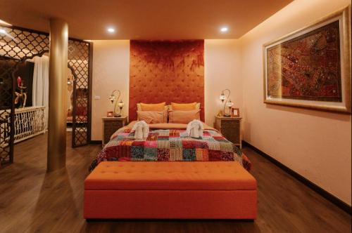 a bedroom with a bed with a quilt on it at Palm Villa - Award Winning Modern Luxury & Exclusive Villa in Chiang Mai