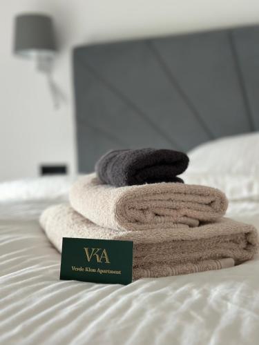 a pile of towels sitting on top of a bed at Verde Klon Apartment- Lotnisko Jasionka in Jasionka