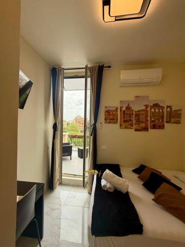 a bedroom with a bed and a sliding glass door at Re di Roma Rooftop in Rome