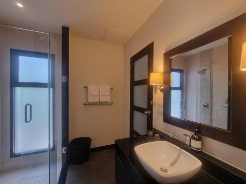 a bathroom with a sink and a mirror and a shower at Tara13-Oriental Villa 3BR private pool Layan Beach in Bang Tao Beach