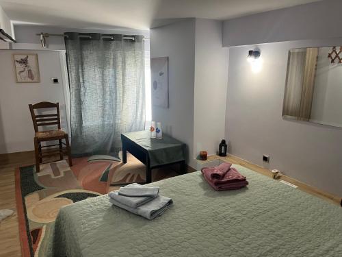 a bedroom with a bed with two towels on it at Chic & Cozy Apartment in Gazi, Athens in Athens