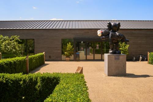 a statue of a bear in front of a building at The Lakes By YOO in Lechlade