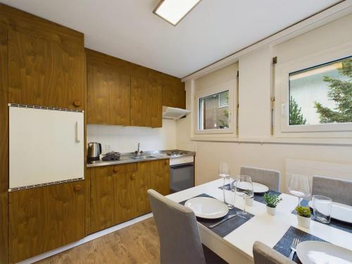 a kitchen with a table with chairs and a whiteboard at Pure Comfort! Entire Apartment with Abundant Space near Zermatt with parking! in Täsch