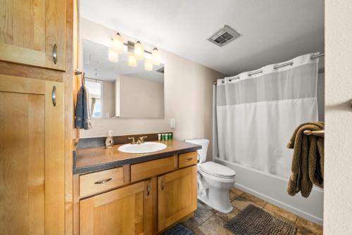 a bathroom with a sink and a toilet and a shower at Ocean Front with Mountain Views and Central AC in Wailuku