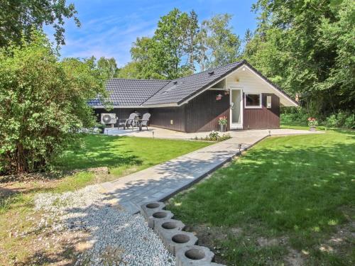 une petite maison avec un jardin et une allée. dans l'établissement Holiday Home Arnsten by Interhome, à Ansager