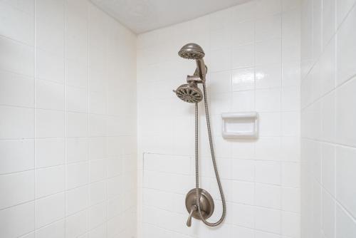 a shower with a shower head in a bathroom at Ocean Front with Mountain Views and Central AC in Wailuku