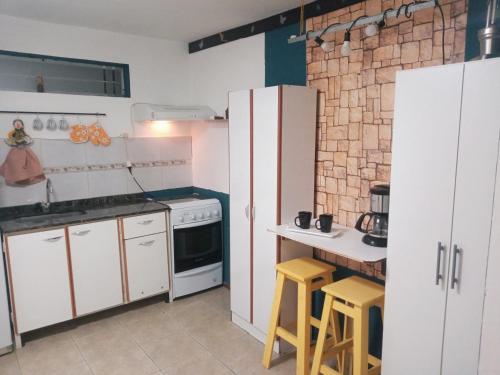 a kitchen with white cabinets and a stove top oven at Don Mario in San Luis