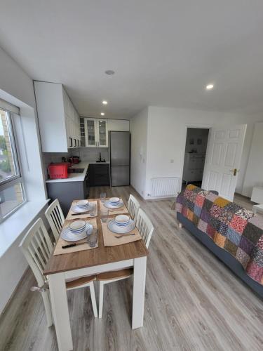 a room with a table and chairs and a bed at The Happy Thoughts Place in Celbridge