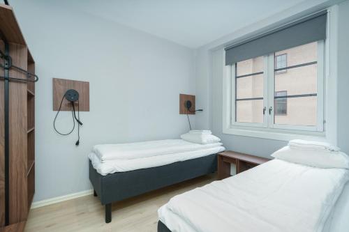 Ένα ή περισσότερα κρεβάτια σε δωμάτιο στο MAYA Apartments - Sentrum
