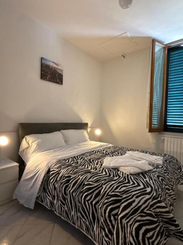 a zebra print bed in a room with a window at Villa Caterina in Florence