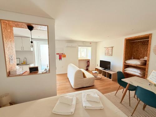 a living room with a couch and a dining room at Casinha no caminho de Santiago in Belinho