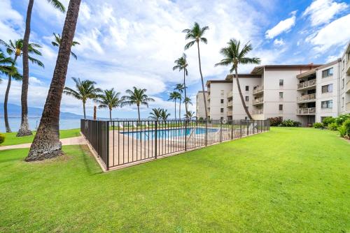a resort with a swimming pool and palm trees at Ocean Front with Mountain Views and Central AC in Wailuku