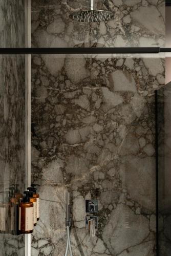 a stone wall in a bathroom with a camera at Casa Guttmann in Rome