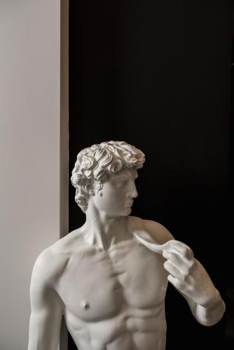 a statue of a shirtless man holding a toothbrush at Casa Guttmann in Rome