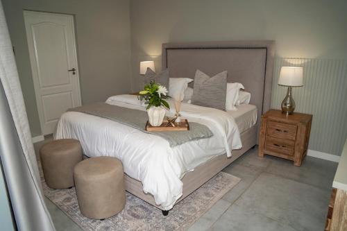 a bedroom with a large bed with flowers on it at Kénōsis Guestfarm - Room 1 in Springbok