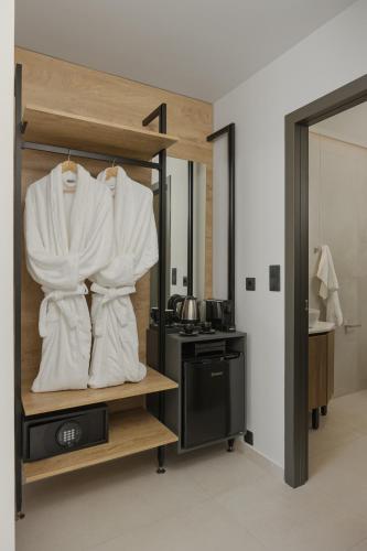 a room with a kitchen with white towels on a shelf at Elysian Castle in Ioannina