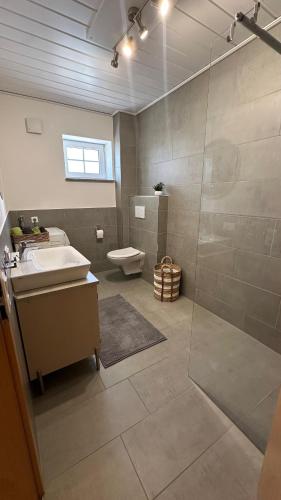 a bathroom with a shower and a sink and a toilet at Stay & Relax in Großostheim