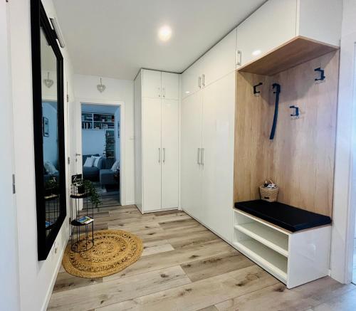 a living room with white cabinets and a television at Downtown Apartment in Trnava