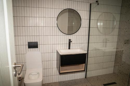 a bathroom with a sink and a mirror and a toilet at Kénōsis Guestfarm - Room 1 in Springbok