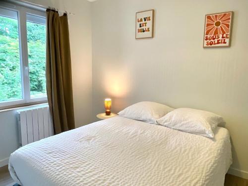 a bedroom with a bed with a candle on a table at La Rive, bord de Saône 