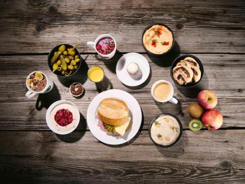 a table topped with plates of food and drinks at B&B HOTEL Frankfurt-Oder in Frankfurt/Oder
