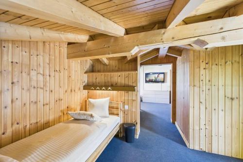 a bedroom with wooden walls and a bed in a room at Family & friends cabin in Saas-Fee in Saas-Fee