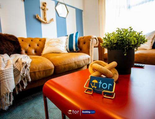 a living room with a couch and a red coffee table at Barry Vibes 3BR House by The One Retreats Short Lets & Serviced Accommodation Barry close to Barry Island in Biglis
