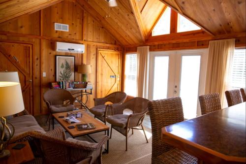 a living room with a table and chairs at Cricket by the Creek - Creek, Gym, Trails, Kayaks in Menlo