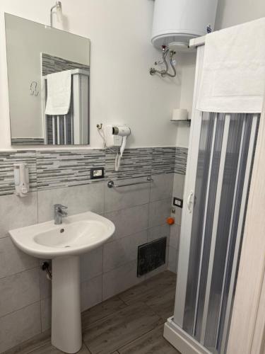 a bathroom with a sink and a mirror at Garibaldi Rooms 2 in Catania