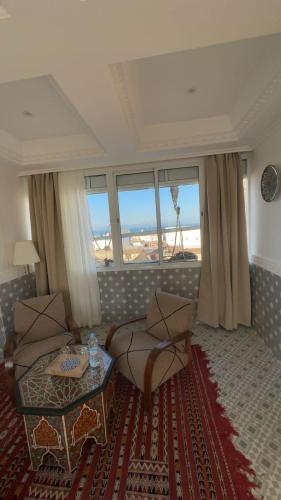 a living room with a couch and a table at RIAD TANJA by chef Moha in Tangier