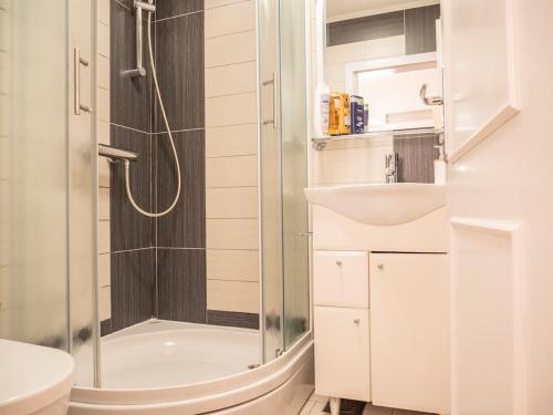 a bathroom with a shower and a toilet and a sink at Apartman Jakša in Hvar