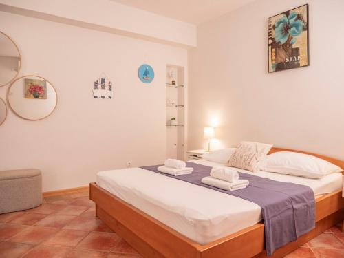 a bedroom with a large bed with towels on it at Apartman Jakša in Hvar