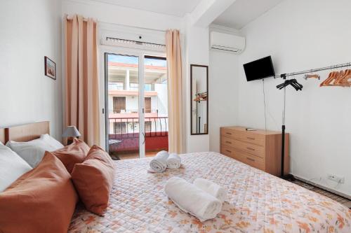 a bedroom with a bed with two towels on it at Frente ao Mar in Monte Gordo