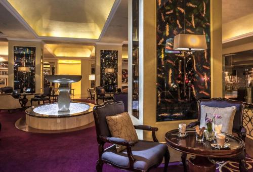 a lobby of a hotel with a table and chairs at Villa Rosa Kempinski in Nairobi