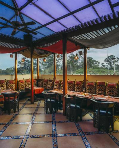 a restaurant with tables and chairs in a room at Villa Rosa Kempinski in Nairobi