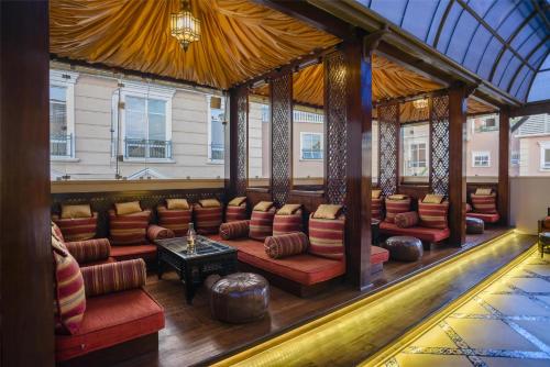 a large room with couches and tables in a building at Villa Rosa Kempinski in Nairobi