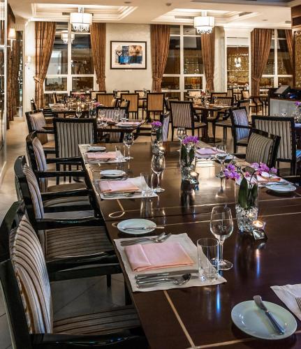 a large dining room with a long table and chairs at Villa Rosa Kempinski in Nairobi
