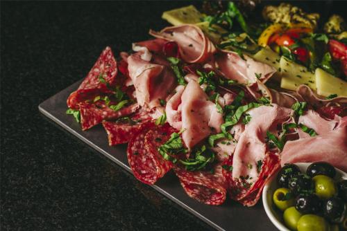 a plate of food with meat and vegetables on a table at Villa Rosa Kempinski in Nairobi