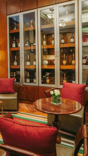 a room with a table and some shelves with tea pots at Villa Rosa Kempinski in Nairobi