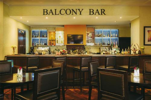 a bar in a restaurant with tables and chairs at Villa Rosa Kempinski in Nairobi