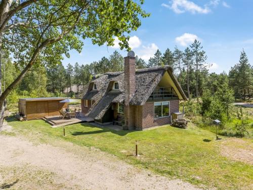 a home with a thatched roof and a yard at Holiday Home Kersta - 3-3km from the sea by Interhome in Kongsmark