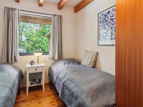 a bedroom with two beds and a window at Holiday Home Kersta - 3-3km from the sea by Interhome in Kongsmark