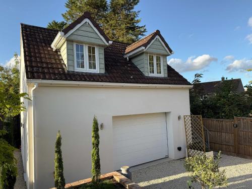 a white garage with a white garage door at The Frog Langport Luxury in Langport