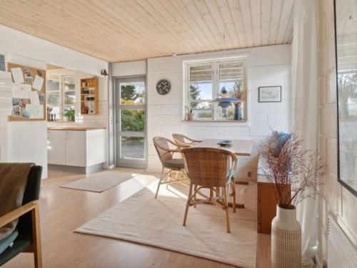 a kitchen and dining room with a table and chairs at Holiday Home Eikka - 100m from the sea by Interhome in Knebel