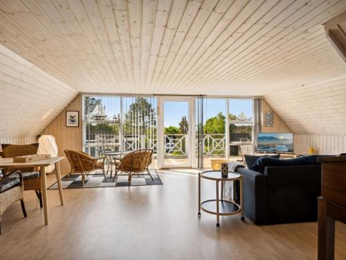 a living room with a couch and chairs at Holiday Home Eikka - 100m from the sea by Interhome in Knebel