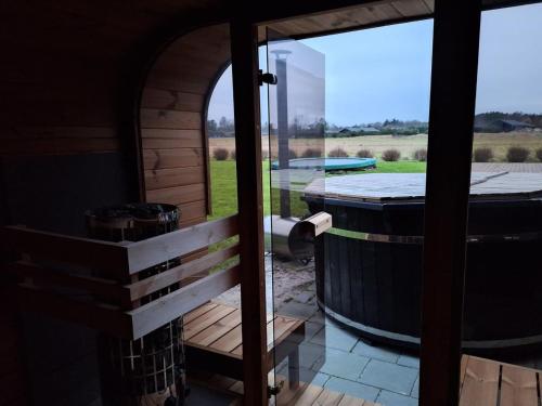 a view from the door of a room with a barrel at Holiday Home Syni - 450m from the sea by Interhome in Sæby