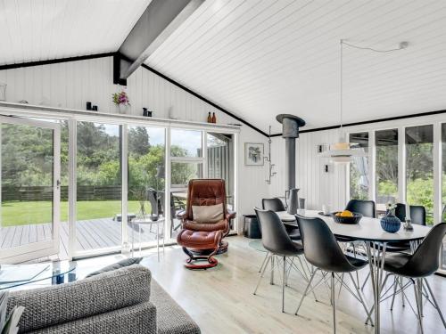 a living room with a table and chairs at Holiday Home Spasena - 600m from the sea by Interhome in Løkken