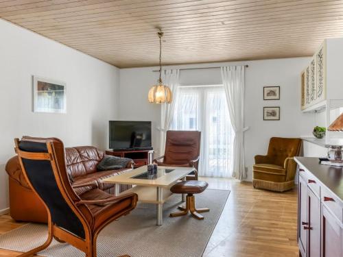 a living room with a couch and a table at Apartment Gilbert - 500m from the sea by Interhome in Sæby